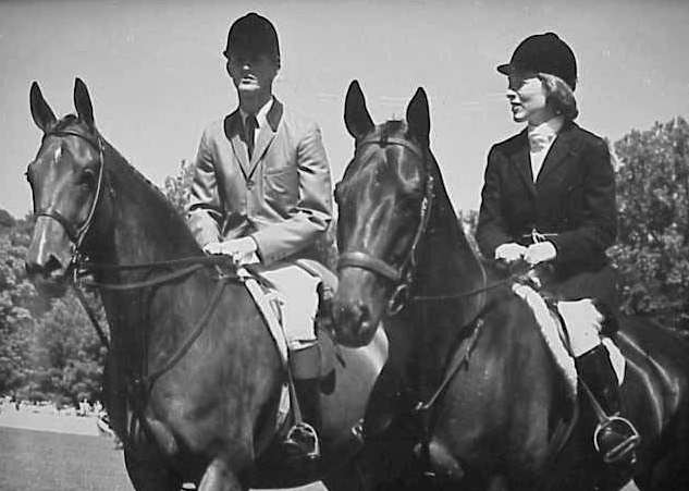 Rodney Jenkins on Blue Plum, owned by Bert Firestone, and Betty Reynolds Oare on Navy Commander in the Opening Parade at the Cleveland Grand Prix in 1965